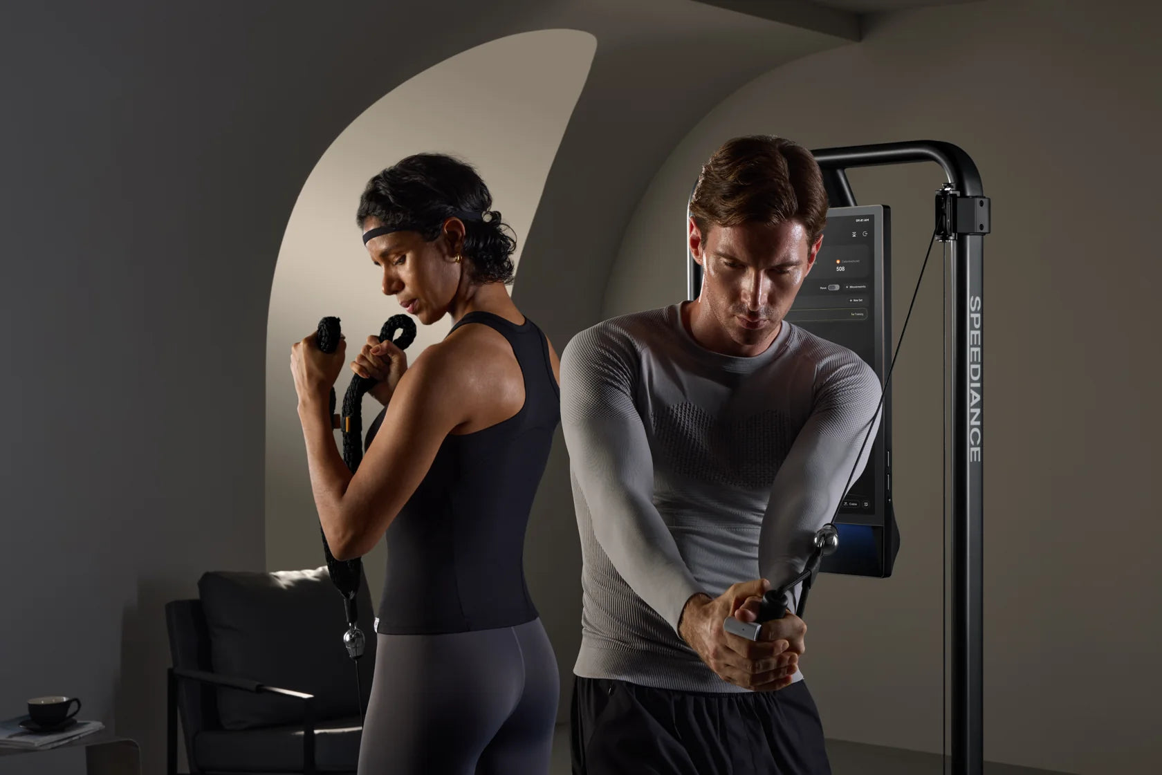 Due adulti si allenano fianco a fianco su Gym Monster 3 in un ambiente domestico